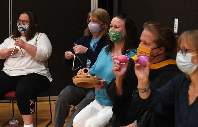 faculty cheering for graduates with noise makers